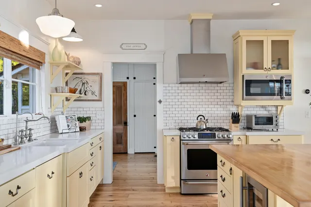 a kitchen with a sink stove and refrigerator