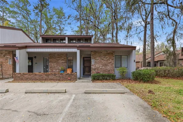 front view of a brick house with a large windows