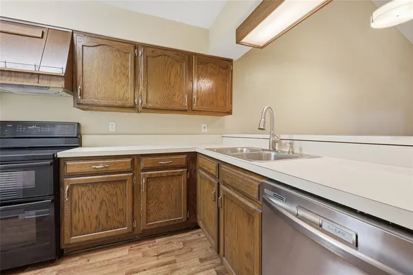 a kitchen with a sink cabinets and stainless steel appliances