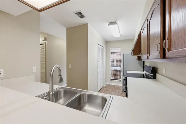 a kitchen with stainless steel appliances a sink and a refrigerator
