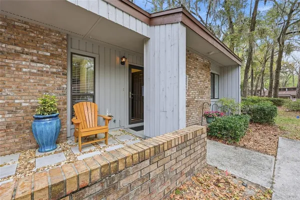 a front view of a house with outdoor seating