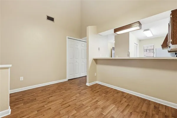 a view of a room with wooden floor and cabinet