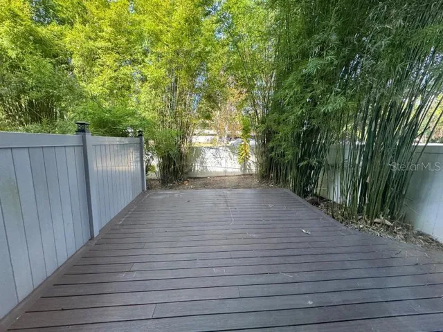 a picture of a living room with a bed and a large window