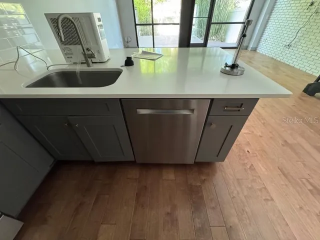 a kitchen with a sink and a mirror
