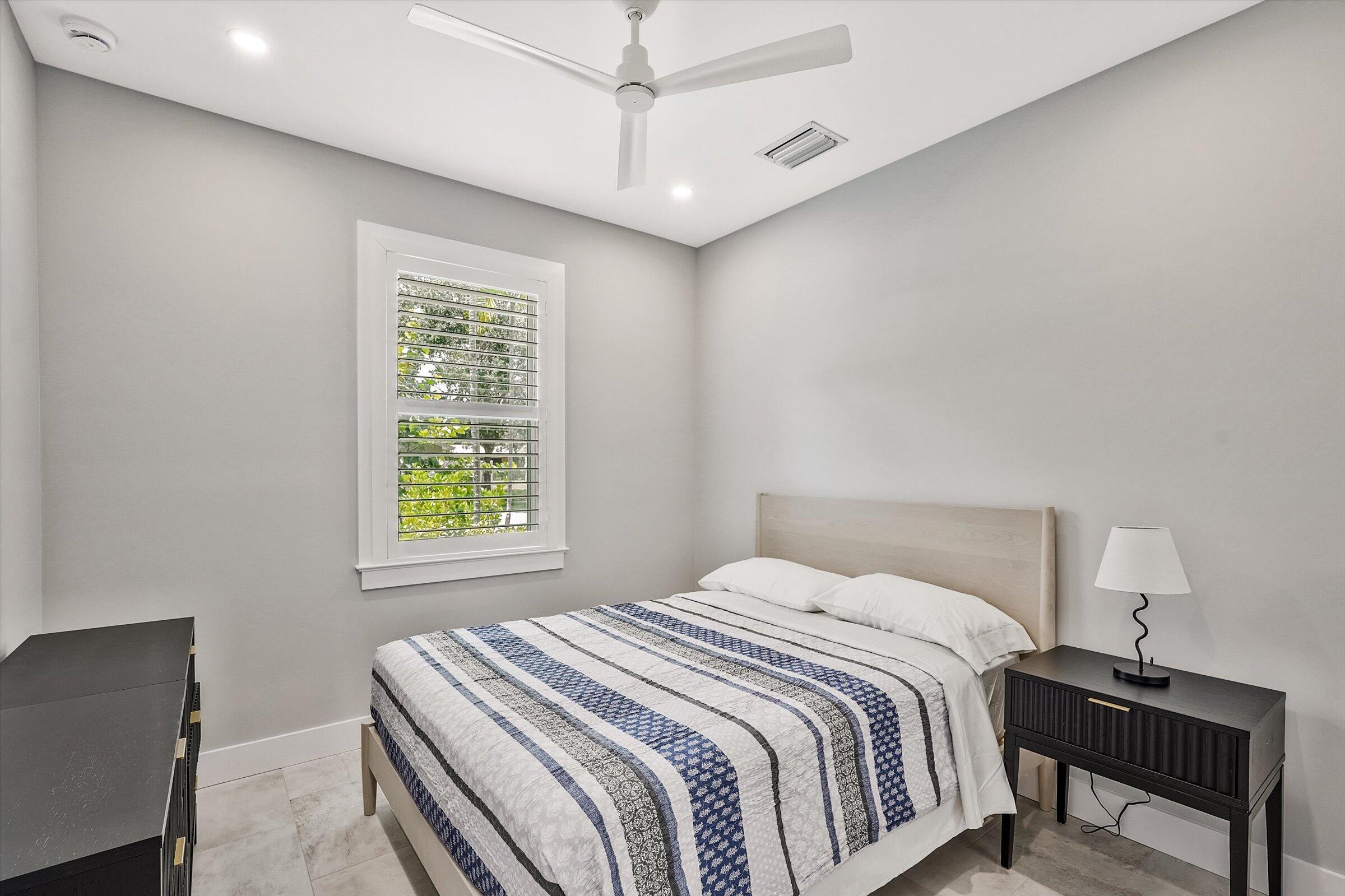 425 Hugh Street Jupiter, FL 33458 - Photo 17 of 41 a bedroom with a bed a desk and chair