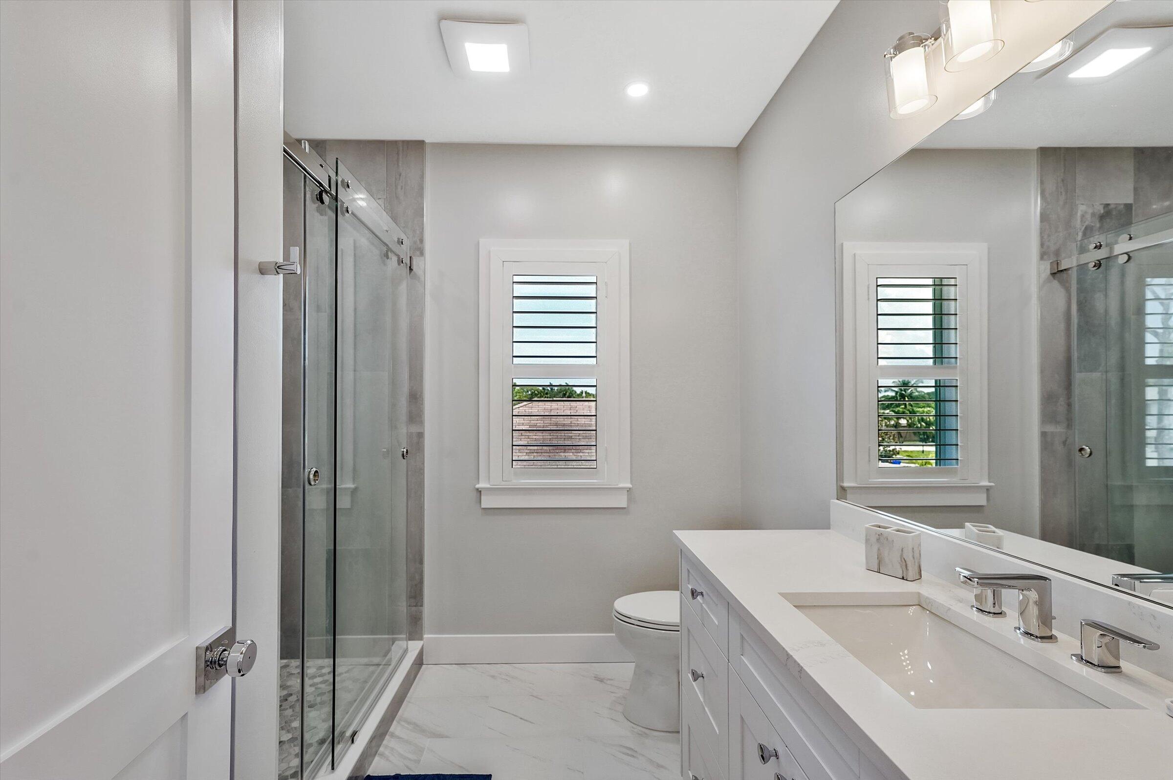 425 Hugh Street Jupiter, FL 33458 - Photo 31 of 41 a bathroom with a sink a toilet and shower