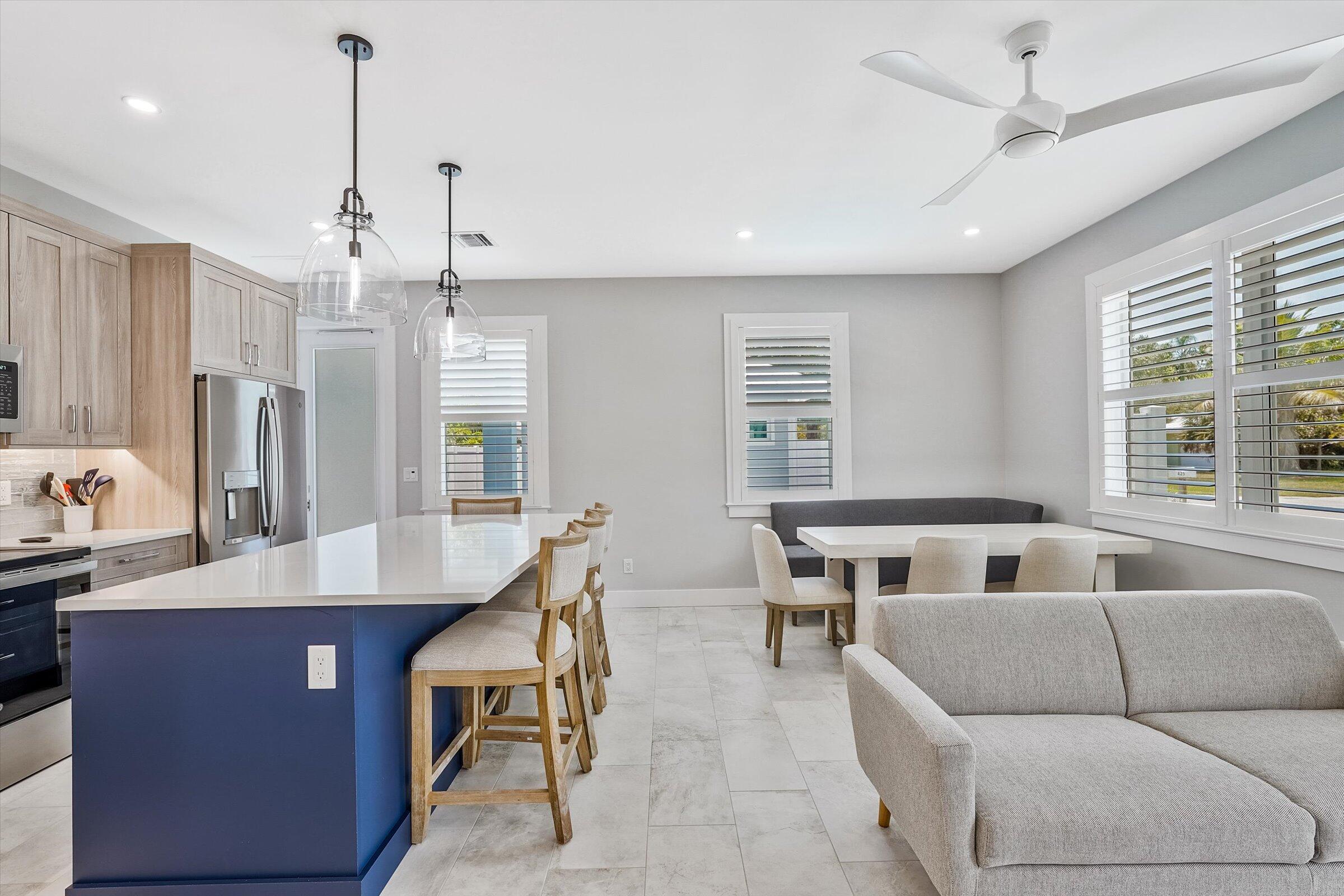 425 Hugh Street Jupiter, FL 33458 - Photo 8 of 41 a living room with kitchen island furniture and a chandelier