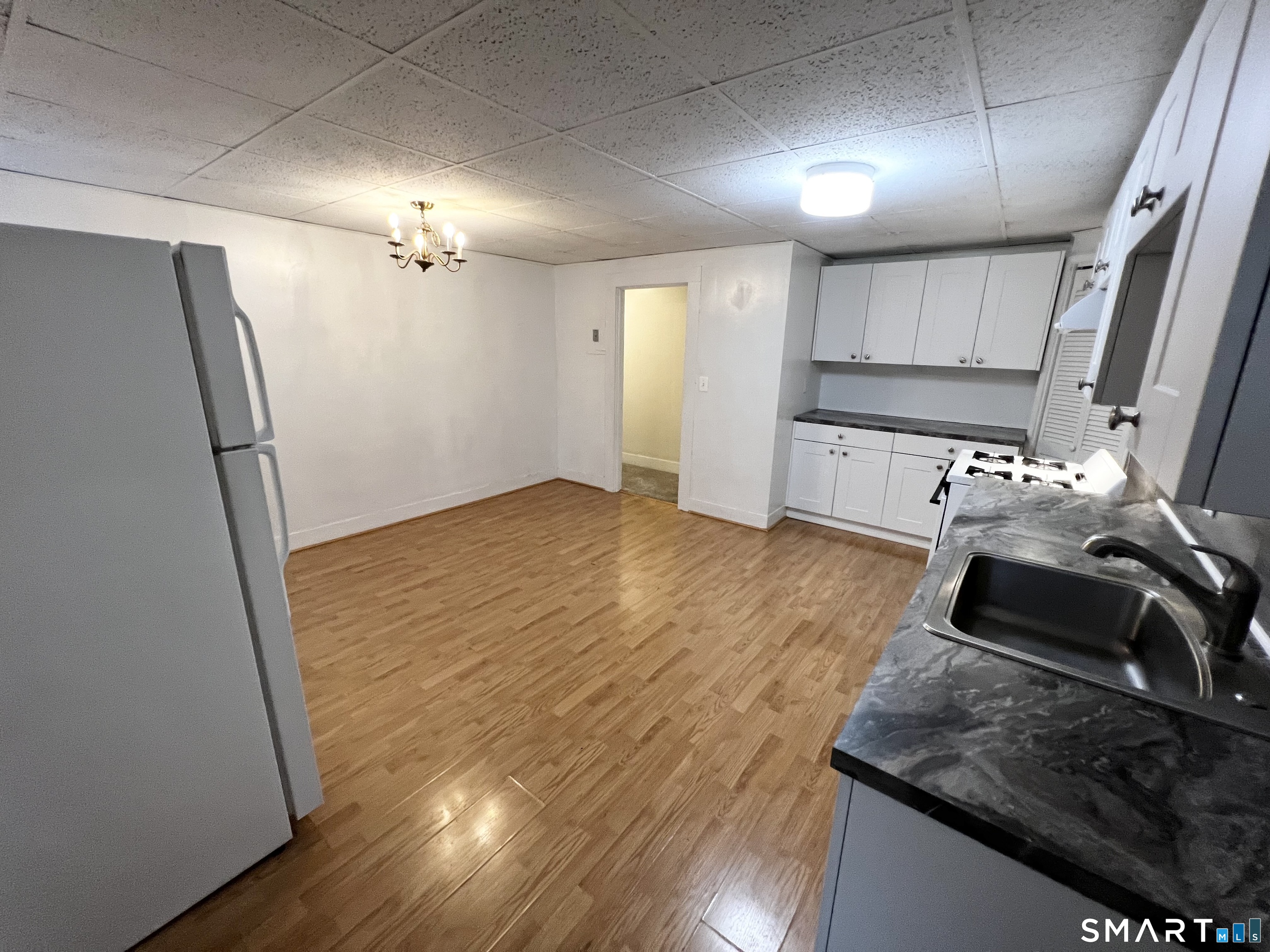 143 William Street, Unit A Middletown, CT 06457 - Photo 6 of 20 a kitchen with granite countertop a stove and a refrigerator