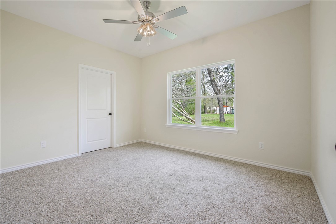 2006 Stevens Drive Bryan, TX 77803 - Photo 11 of 18 an empty room with windows and fan