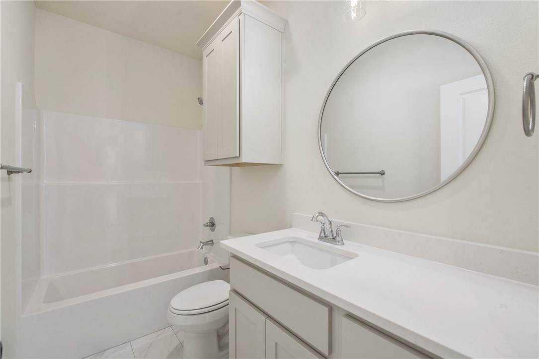 2006 Stevens Drive Bryan, TX 77803 - Photo 12 of 18 a bathroom with a sink a toilet and a mirror