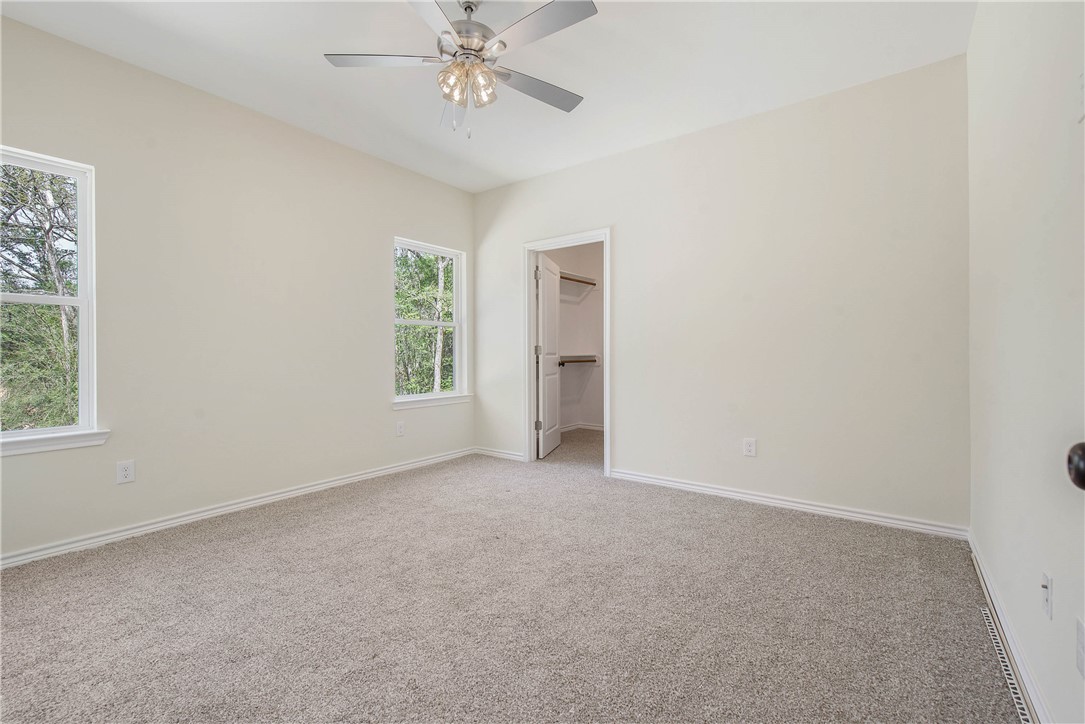 2006 Stevens Drive Bryan, TX 77803 - Photo 14 of 18 an empty room with a window and a fan