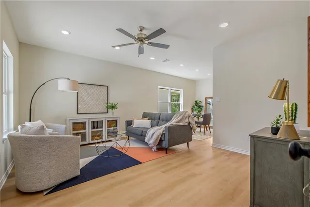 a living room with furniture and a potted plant