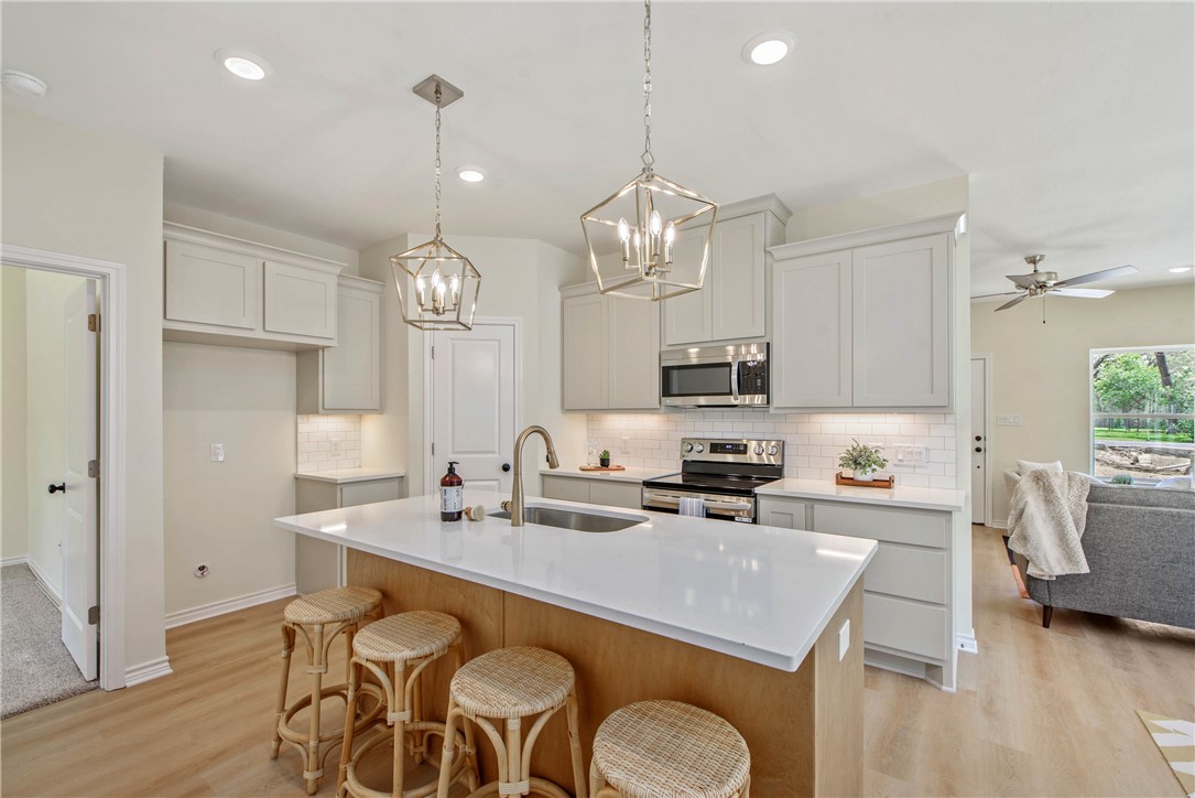 2006 Stevens Drive Bryan, TX 77803 - Photo 7 of 18 a kitchen with a dining table chairs stove and cabinets