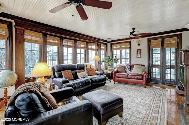 a living room with furniture and a floor to ceiling window