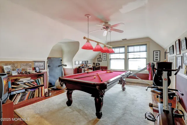 a room with musical instruments pool table and windows