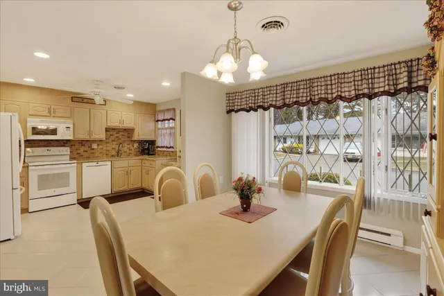 a kitchen with granite countertop a table and chairs