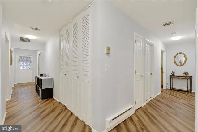 a view of a room with wooden floor and furniture