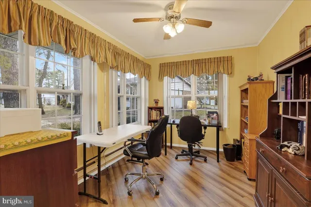 a view of a livingroom with workspace and a window