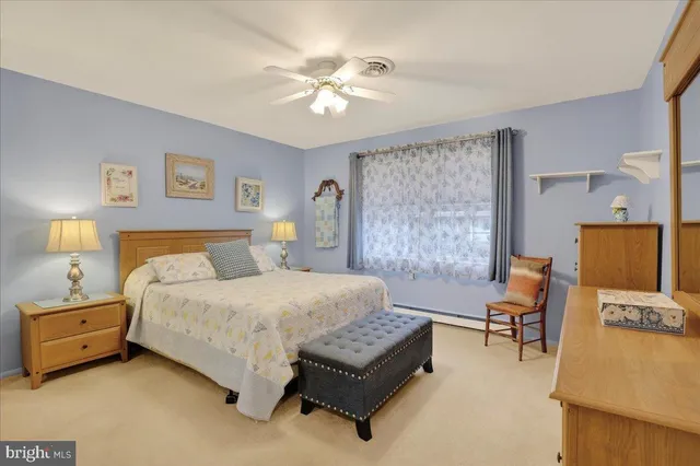 a bedroom with a bed dresser and a window