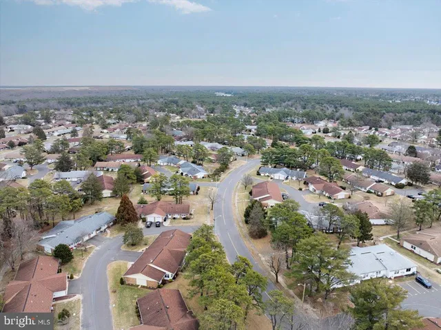 an aerial view of a backyard and swimming pool