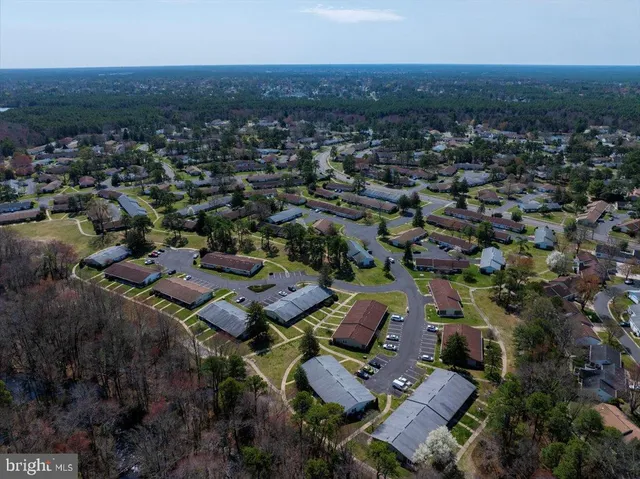 an aerial view of a house with a yard and lake view