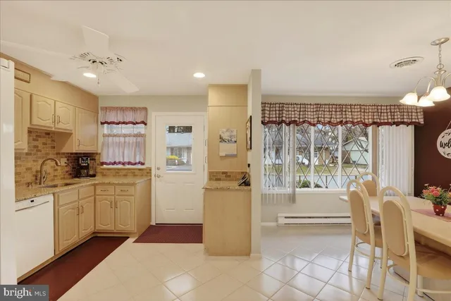 a kitchen with a refrigerator and a stove top oven