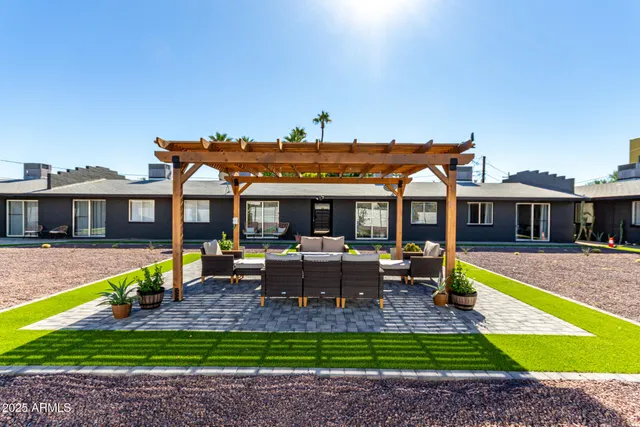 a view of a house with swimming pool and sitting area