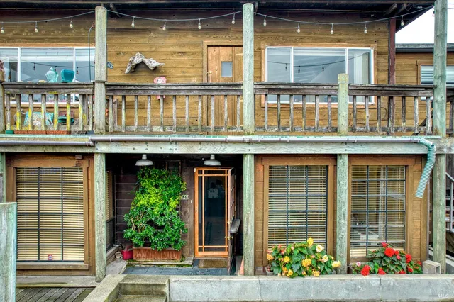 a front view of a building with potted plants