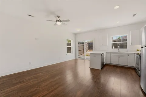 a view of a room with wooden floor and white walls