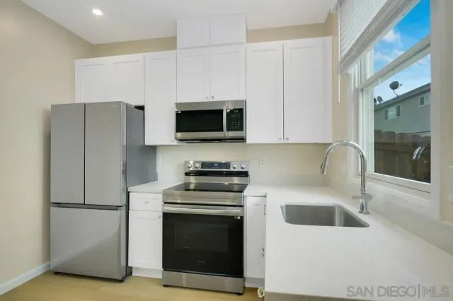 a kitchen with stainless steel appliances a refrigerator stove and microwave