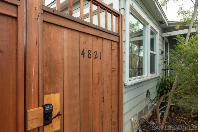 a view of a house with a yard and potted plants