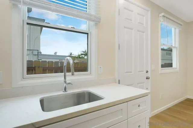 a kitchen with a refrigerator and a stove top oven