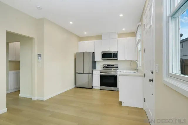 a kitchen with stainless steel appliances a stove a microwave and sink