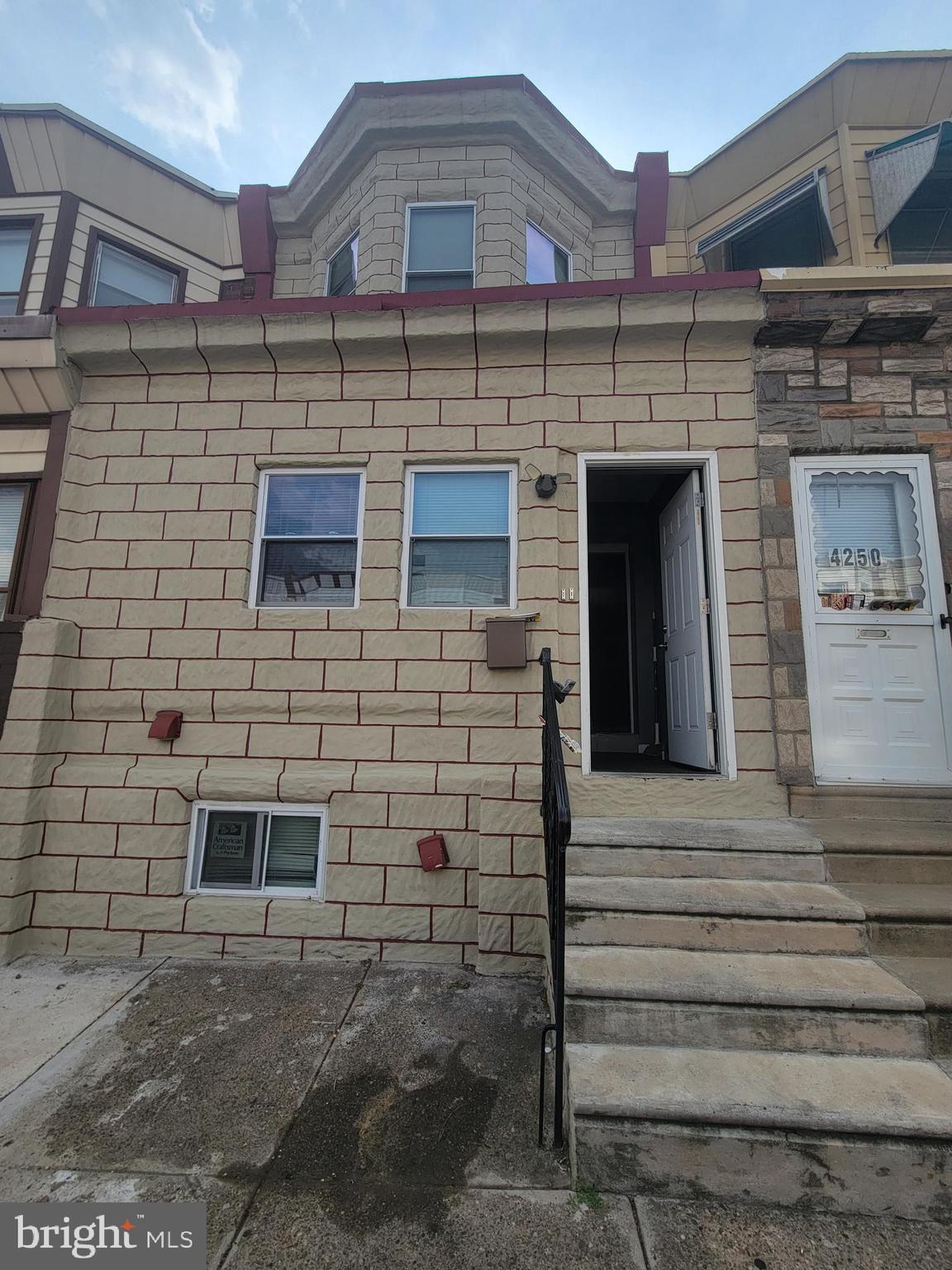 4248 North 7th Street, Unit 2 Philadelphia, PA 19140 - Photo 1 of 6 a front view of a building with a garden
