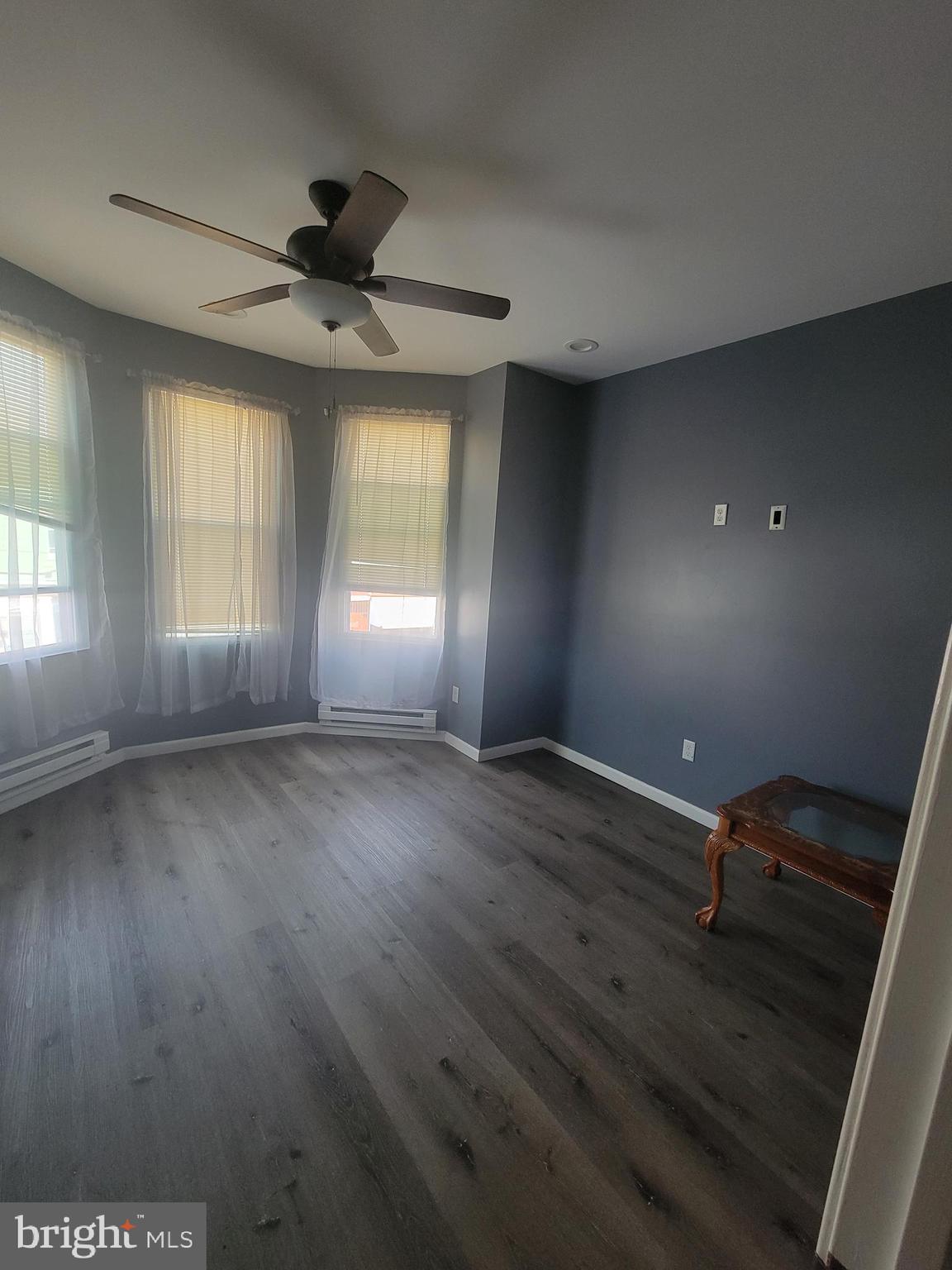 4248 North 7th Street, Unit 2 Philadelphia, PA 19140 - Photo 4 of 6 a view of empty room with wooden floor and fan