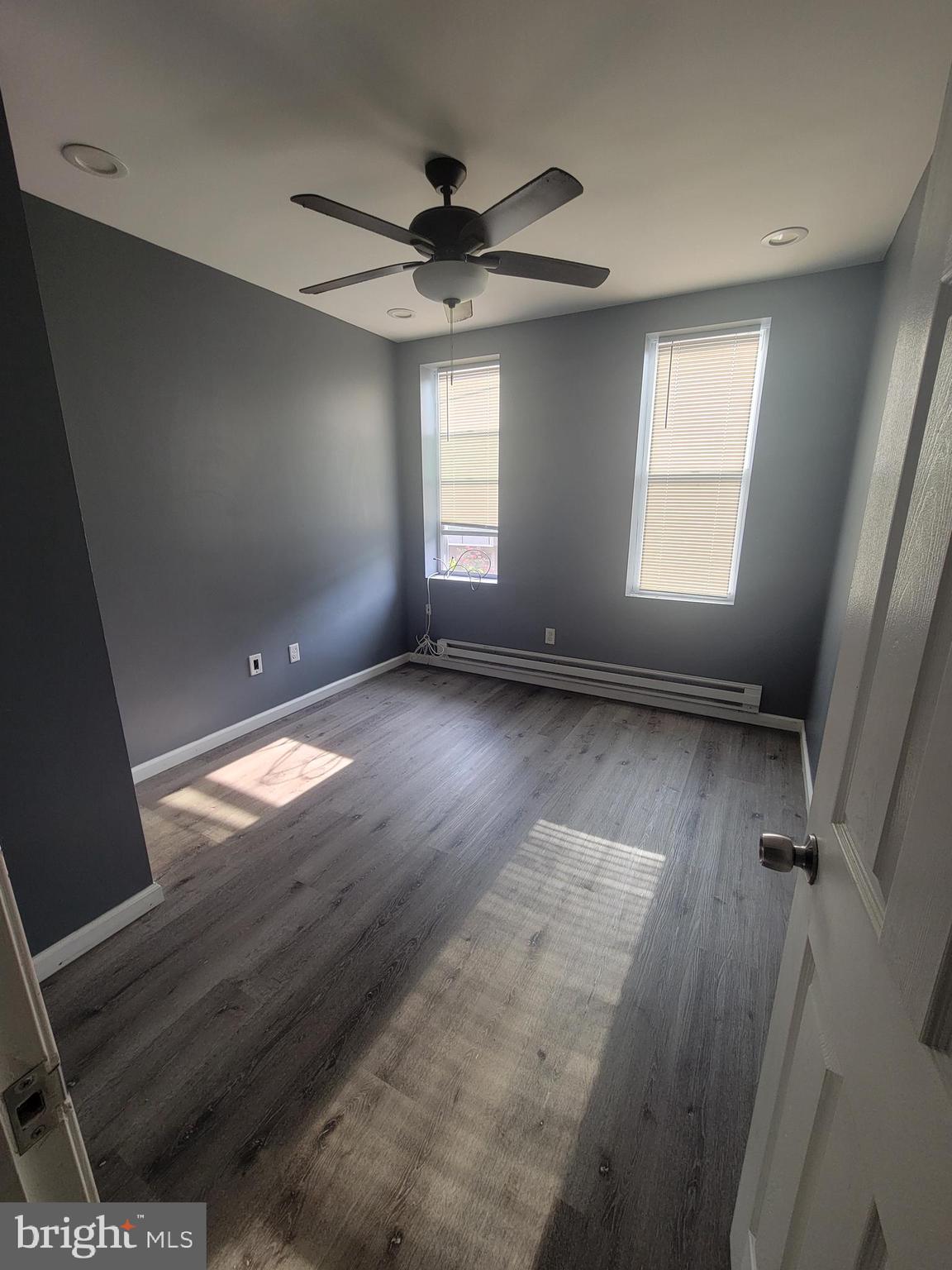 4248 North 7th Street, Unit 2 Philadelphia, PA 19140 - Photo 5 of 6 wooden floor in an empty room with a window