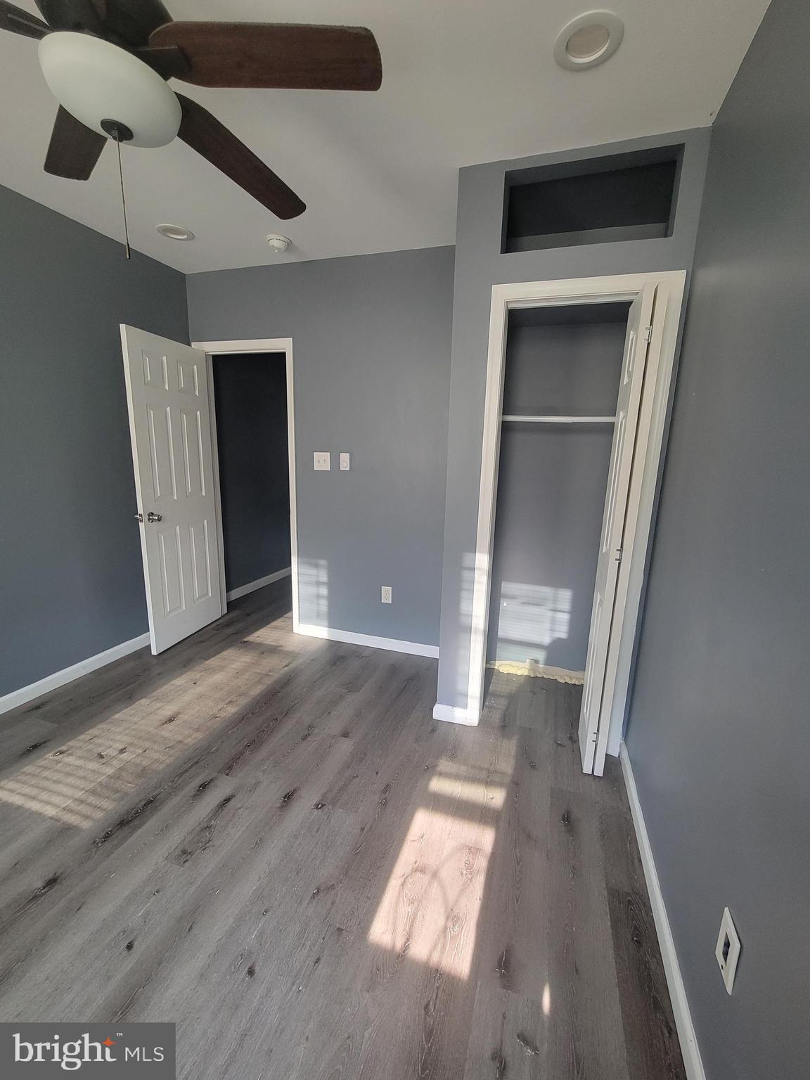 4248 North 7th Street, Unit 2 Philadelphia, PA 19140 - Photo 6 of 6 an empty room with wooden floor cabinet and windows