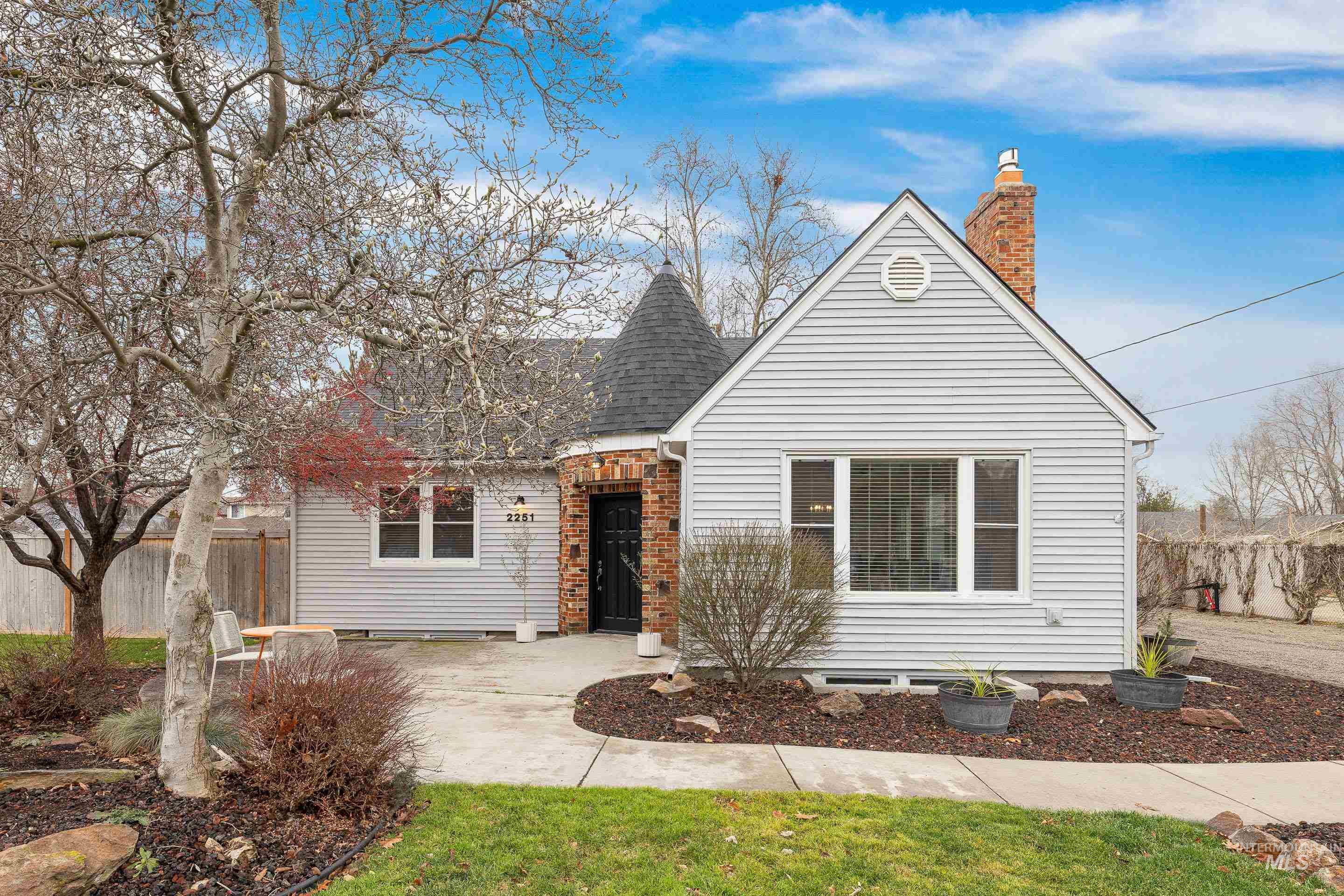 View of front of property featuring a chimney and roof with shingles