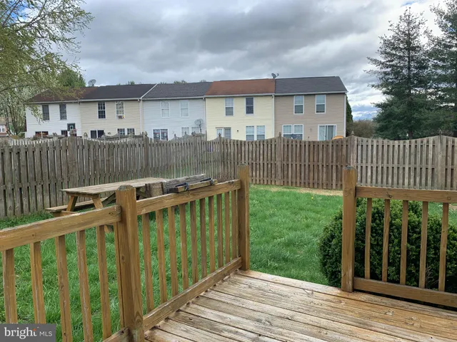 a view of a house with a wooden deck