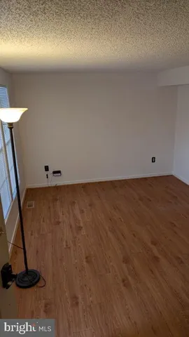 a view of room with wooden floor