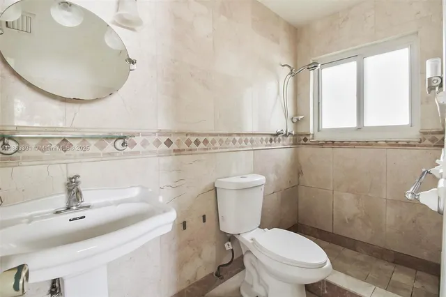 an empty room with a window and a kitchen