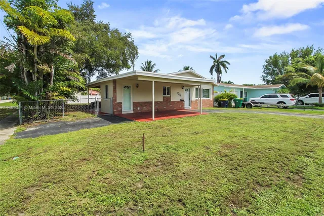 a view of a house with a yard patio and sitting area