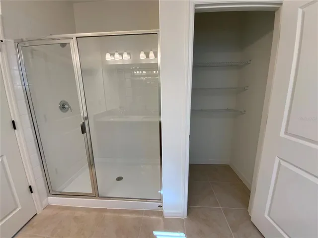 a bathroom with a glass shower door