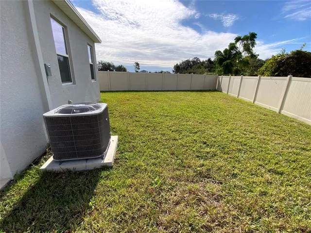 a view of a swimming pool with an outdoor seating and a yard