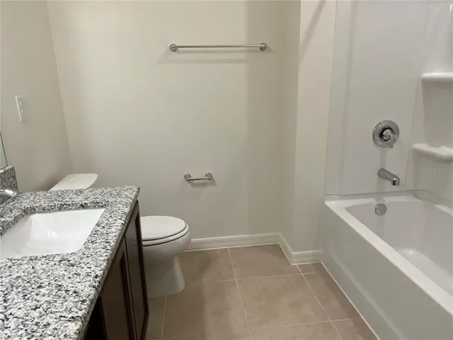 a bathroom with a sink a toilet and bathtub