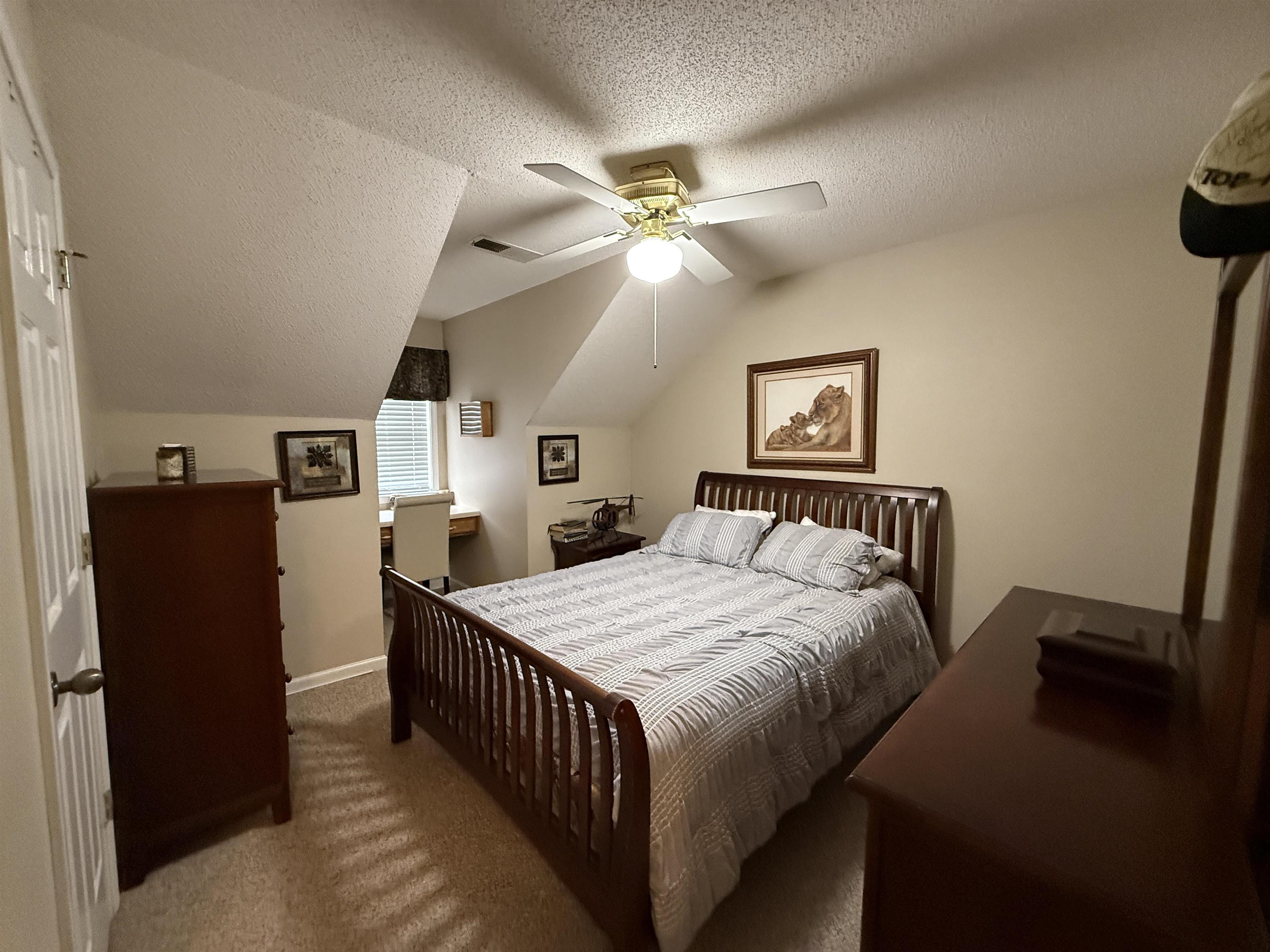 910 Highway 196 Piperton, TN 38017 - Photo 14 of 23 a bedroom with a bed and a chandelier