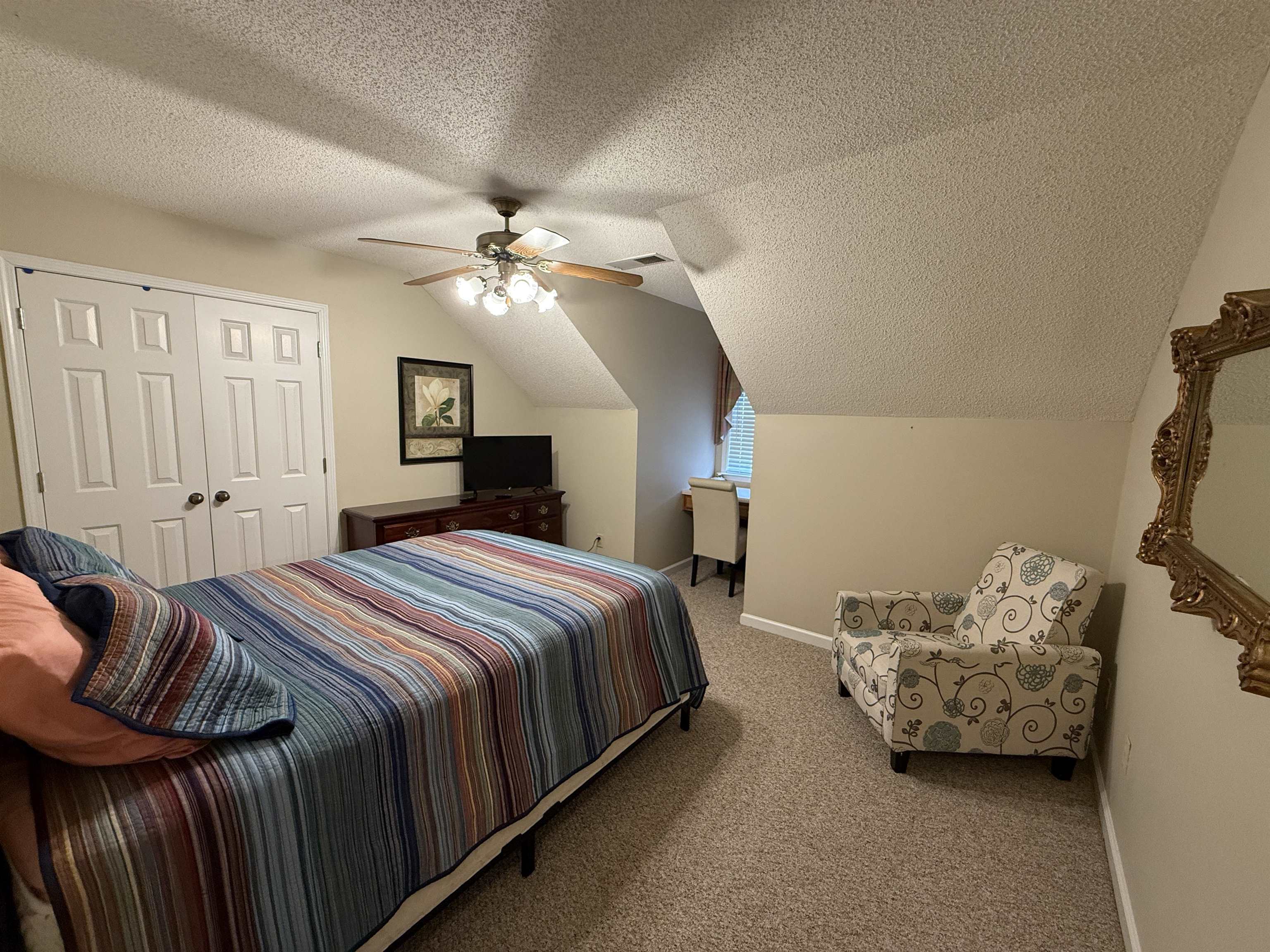 910 Highway 196 Piperton, TN 38017 - Photo 17 of 23 a bedroom with a bed and a chandelier