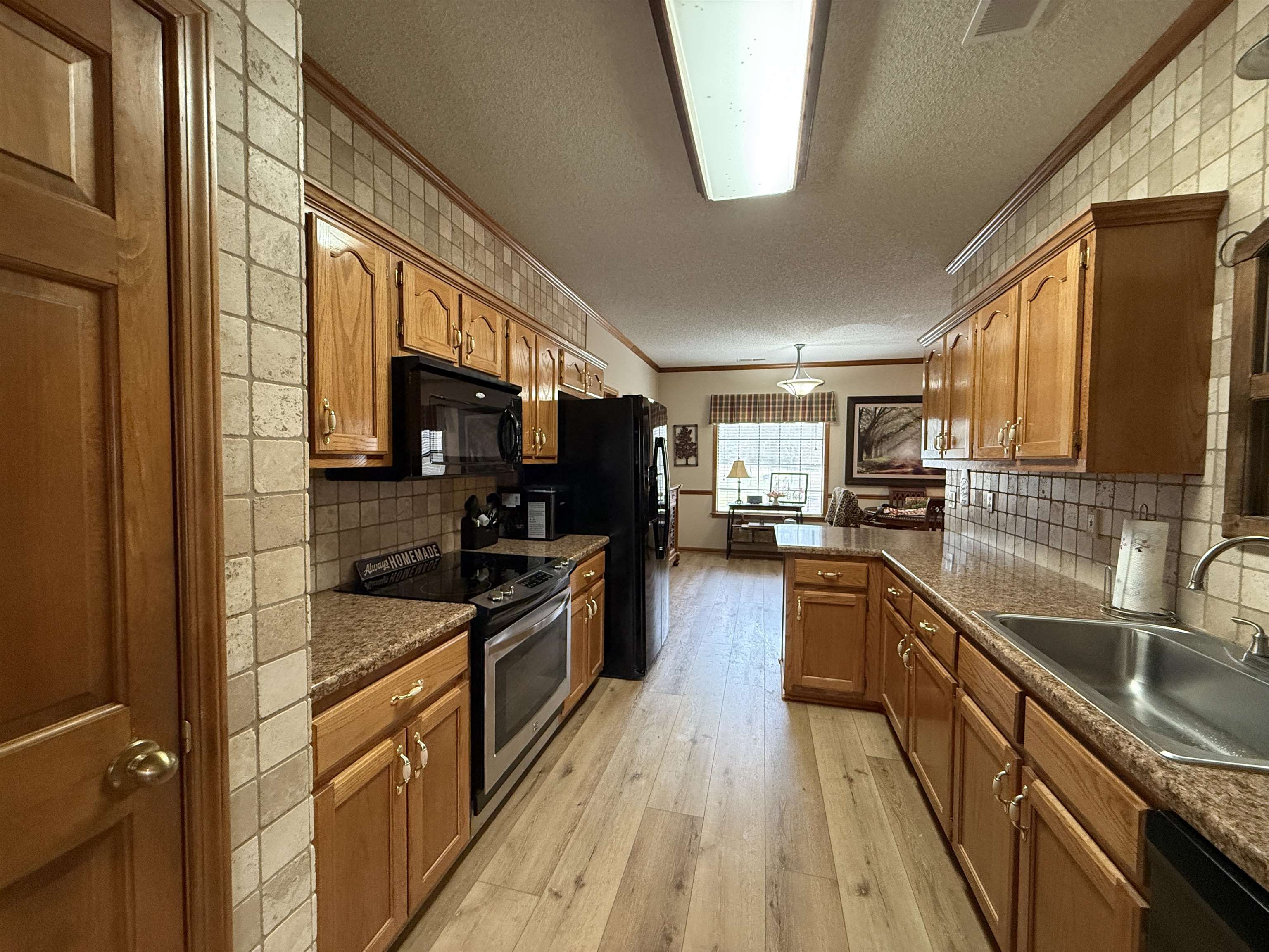 910 Highway 196 Piperton, TN 38017 - Photo 8 of 23 a kitchen with stainless steel appliances granite countertop sink stove microwave and cabinets