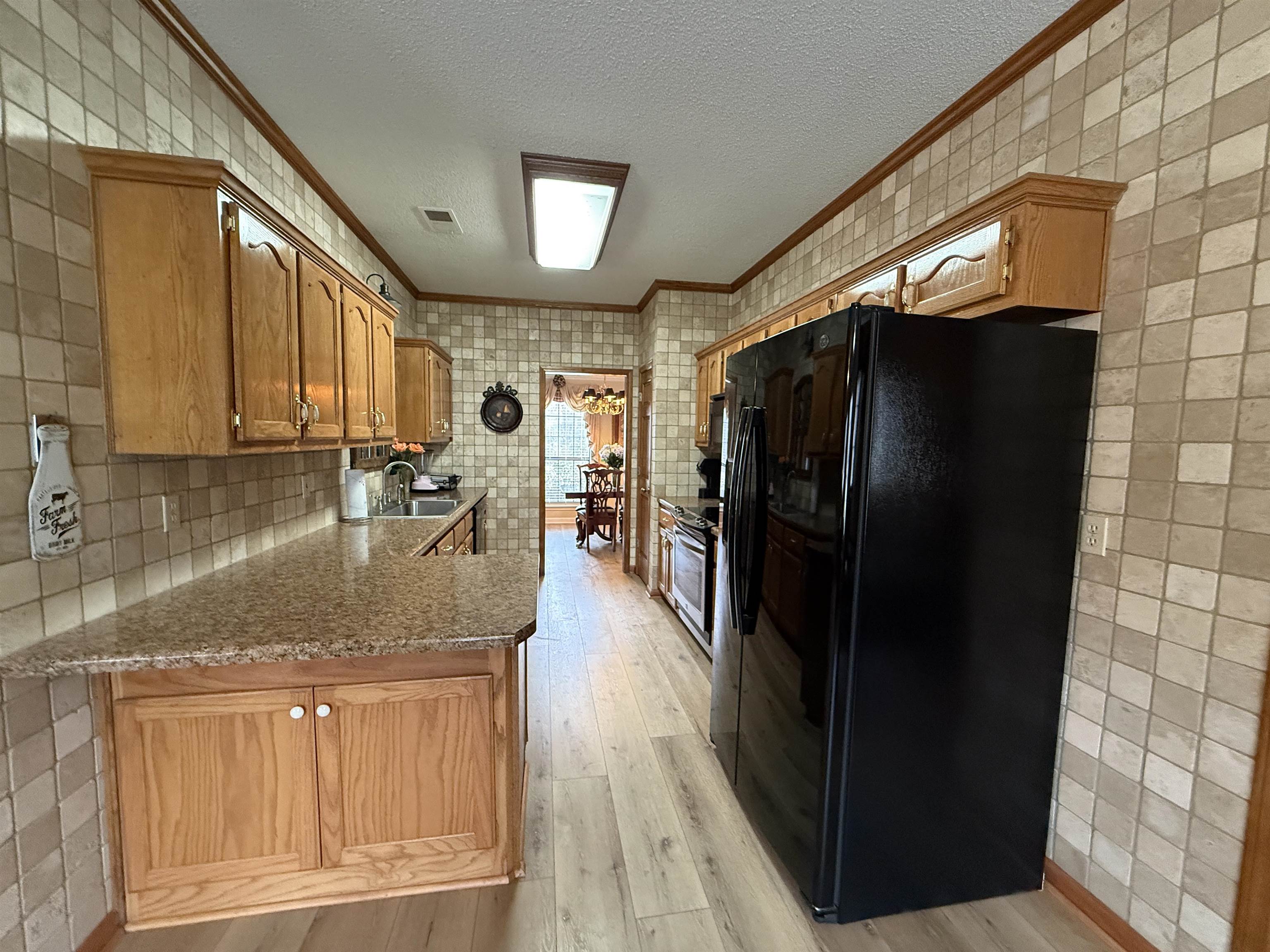 910 Highway 196 Piperton, TN 38017 - Photo 9 of 23 a kitchen with stainless steel appliances granite countertop a refrigerator and a sink