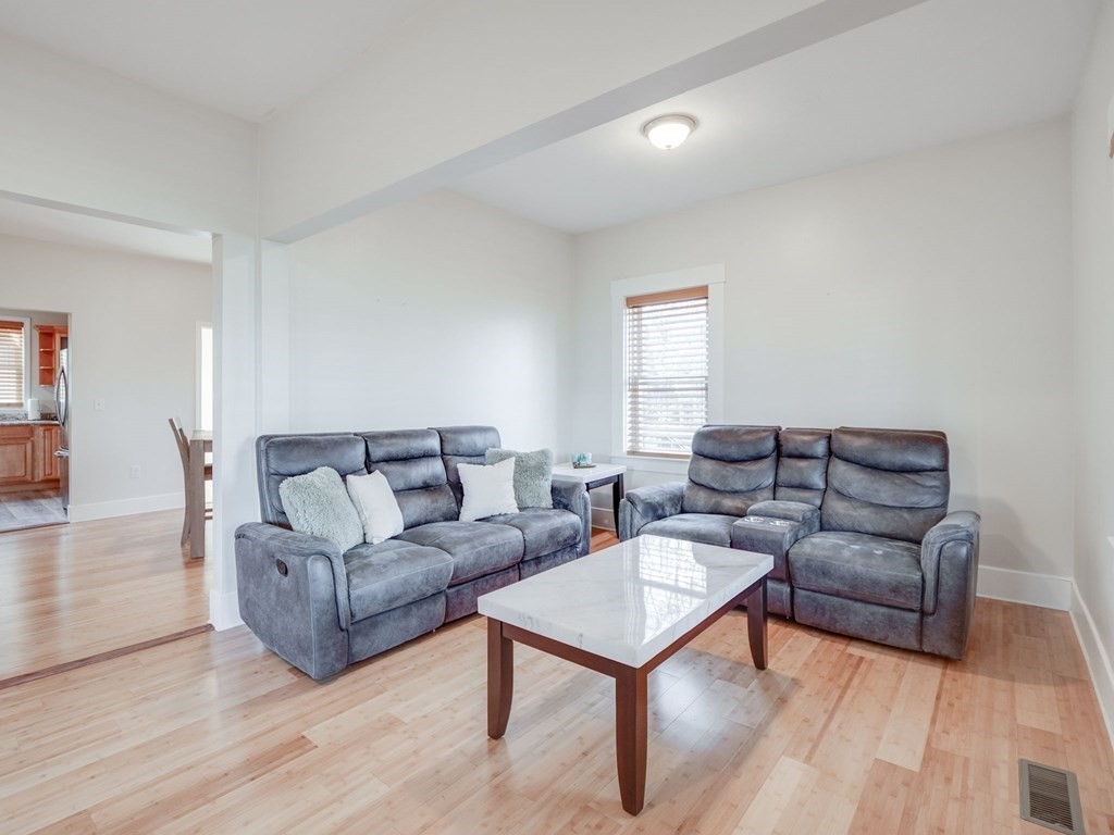 116 Middlesex Road Tyngsborough, MA 01879 - Photo 11 of 42 a living room with furniture and a wooden floor